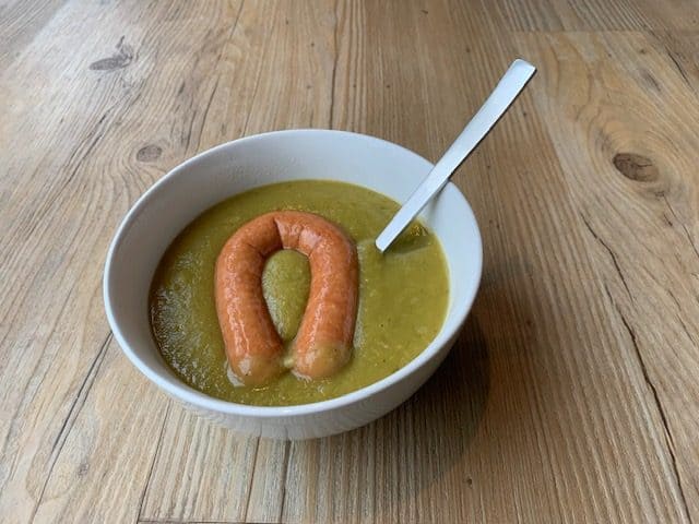 Dutch green pea soup with the traditional sausage