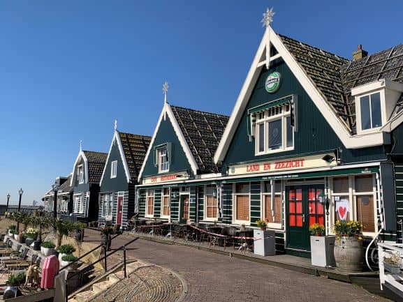 a row of typical green houses on Marke, one of the most beautiful villages in The Netherlands