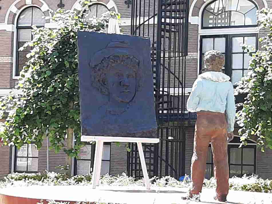 A statue of Rembrandt as a young painter in front of his birth house in Leiden