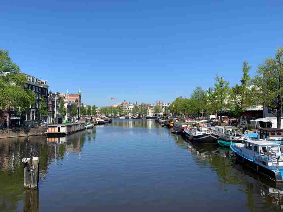 View of the Amstel River on a sunny summer day towards the center of Amsterdam
