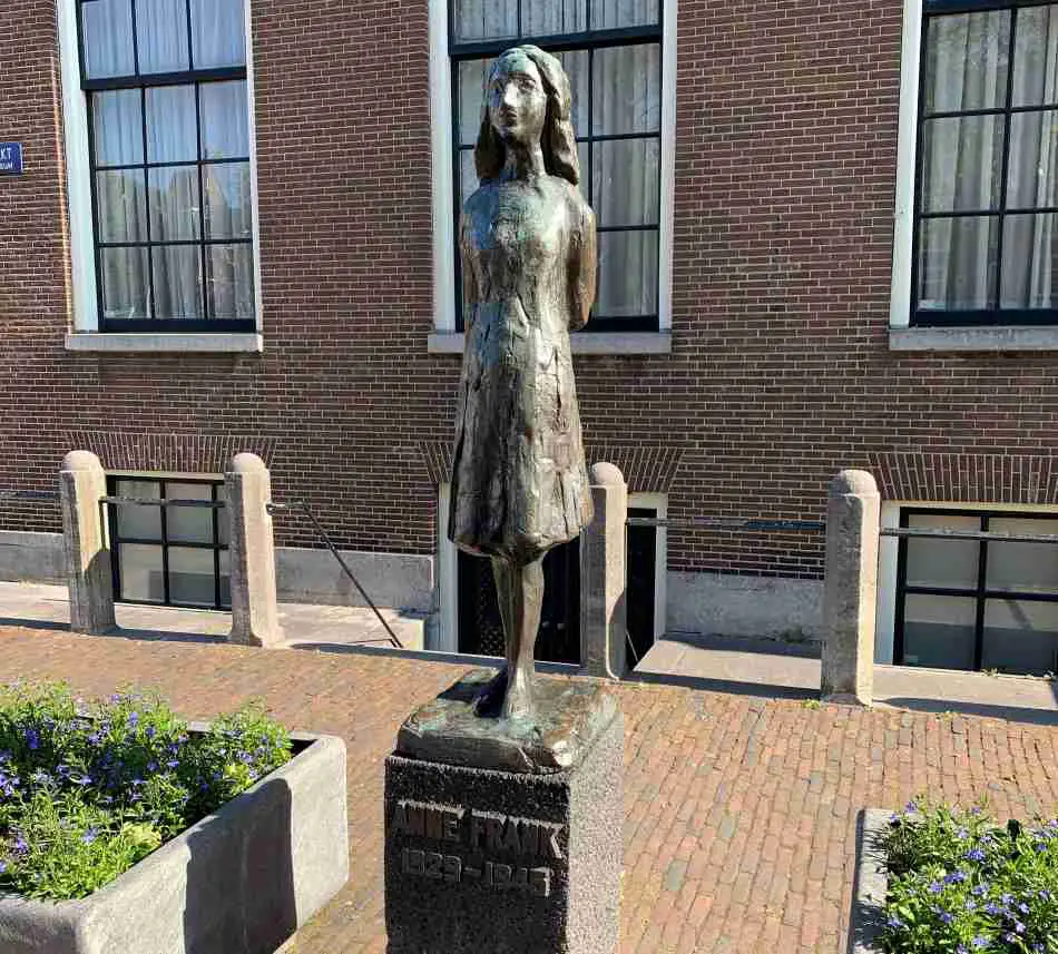 The statue of Anne Frank next to the Anne Frank House