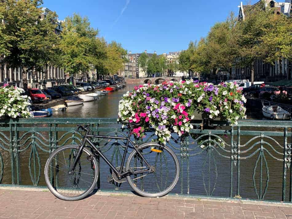 Flowers and bikes on a bridge over one of the canals in Amsterdam