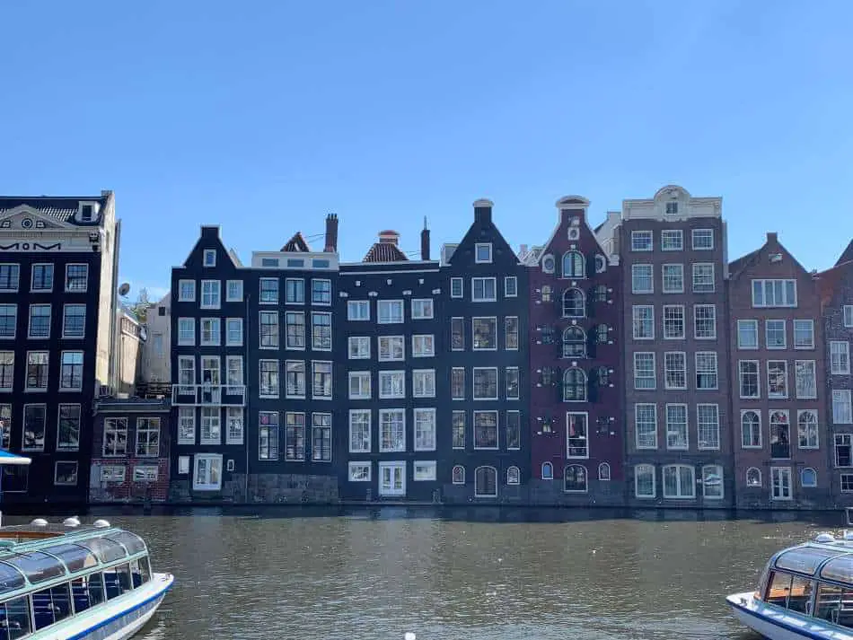 Dancing canal houses on the Damrak in Amsterdam, viewed from Damrak